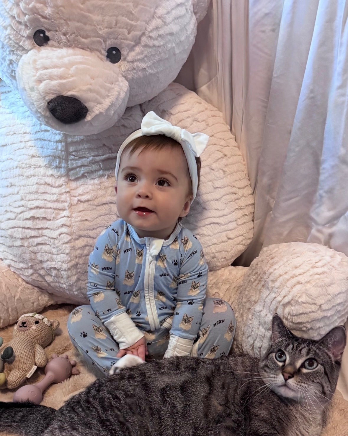 Our daughter wearing The Sam footie next to Sam, the real cat behind the print